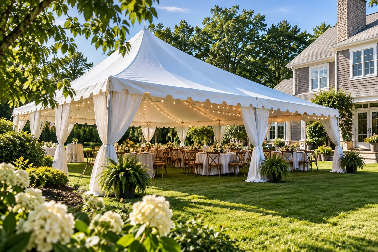 Outdoor event tent beside a landscaped residential property.
